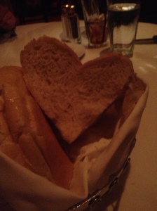 Loaf of bread served in a restaurant.  One piece was found in the bread basket, squashed into the shape of a heart.  Found by Morgan Madsen.